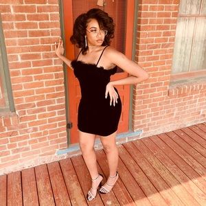 Velvet black mini dress with feather detail